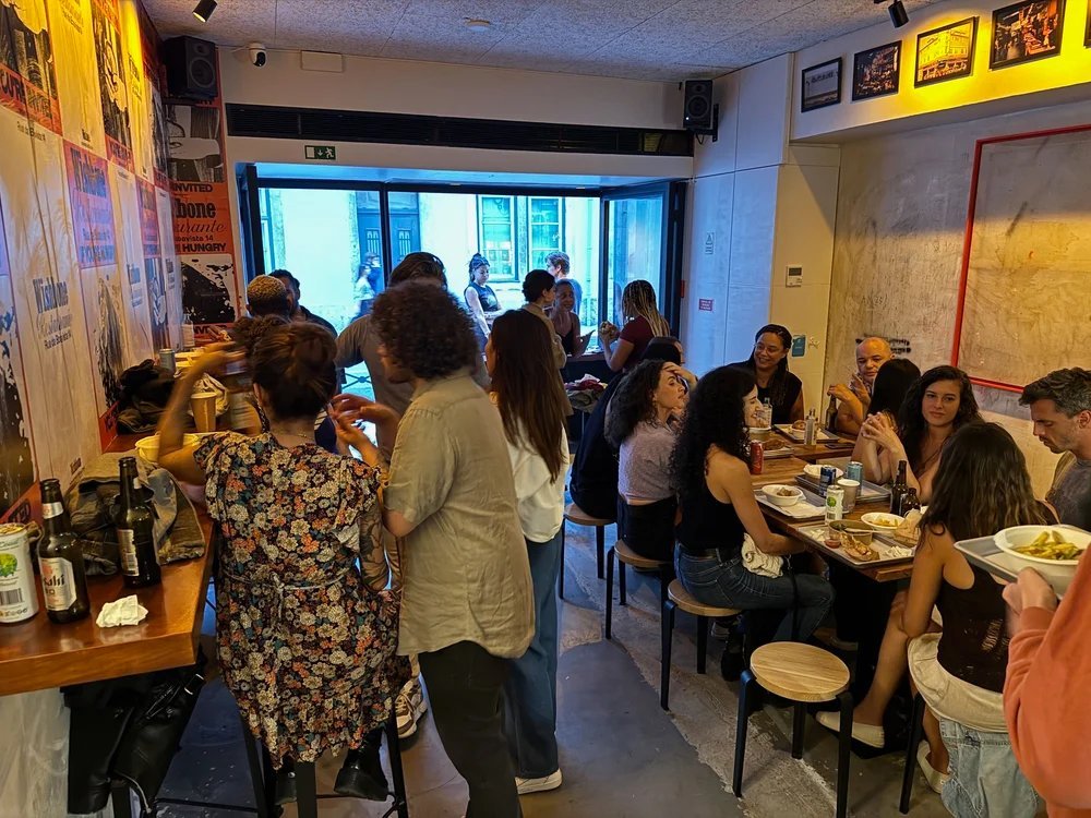 Friends eating karaage fried chicken at Wishbone in Bica, near the Santa Catarina viewpoint in Lisbon