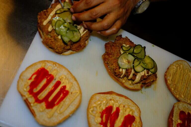 Karaage chicken sandwiches being assembled with pickles and Kewpie mayo at Wishbone in Bica, Lisbon